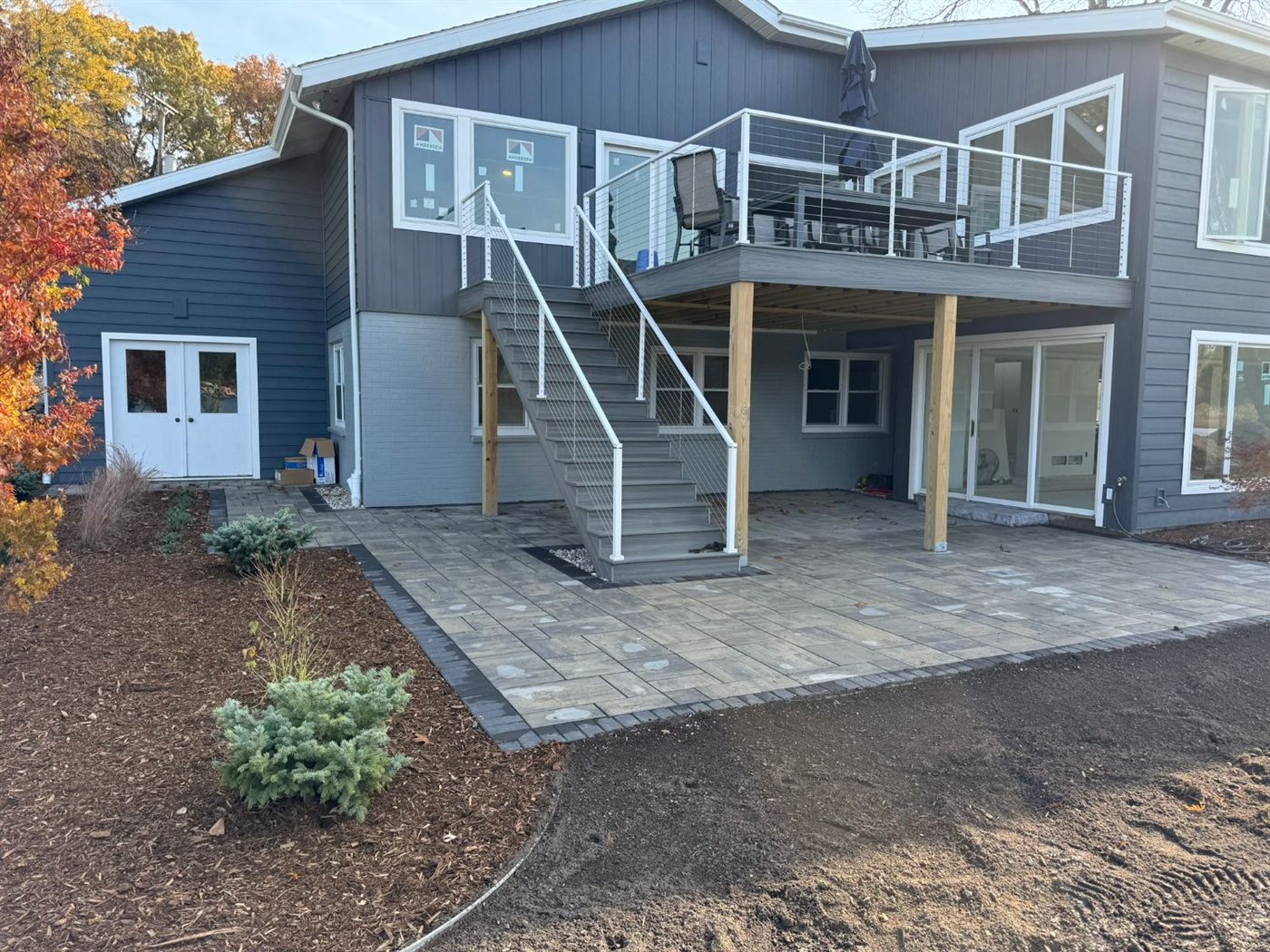 Finished permeable paver patio beneath the deck with new plantings
