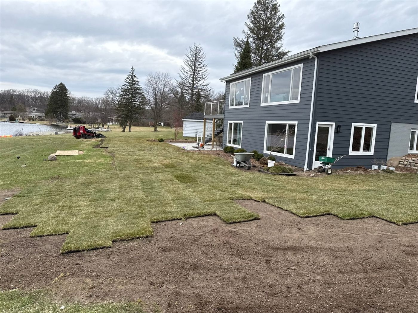 New sod being laid across the lakefront lawn