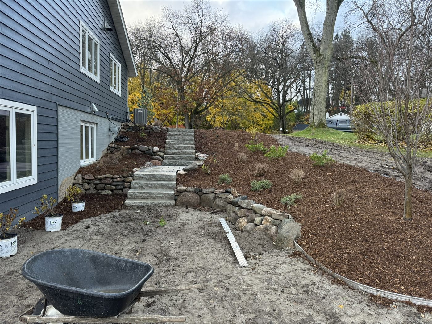 New stone steps, retaining wall, and mulched planting beds