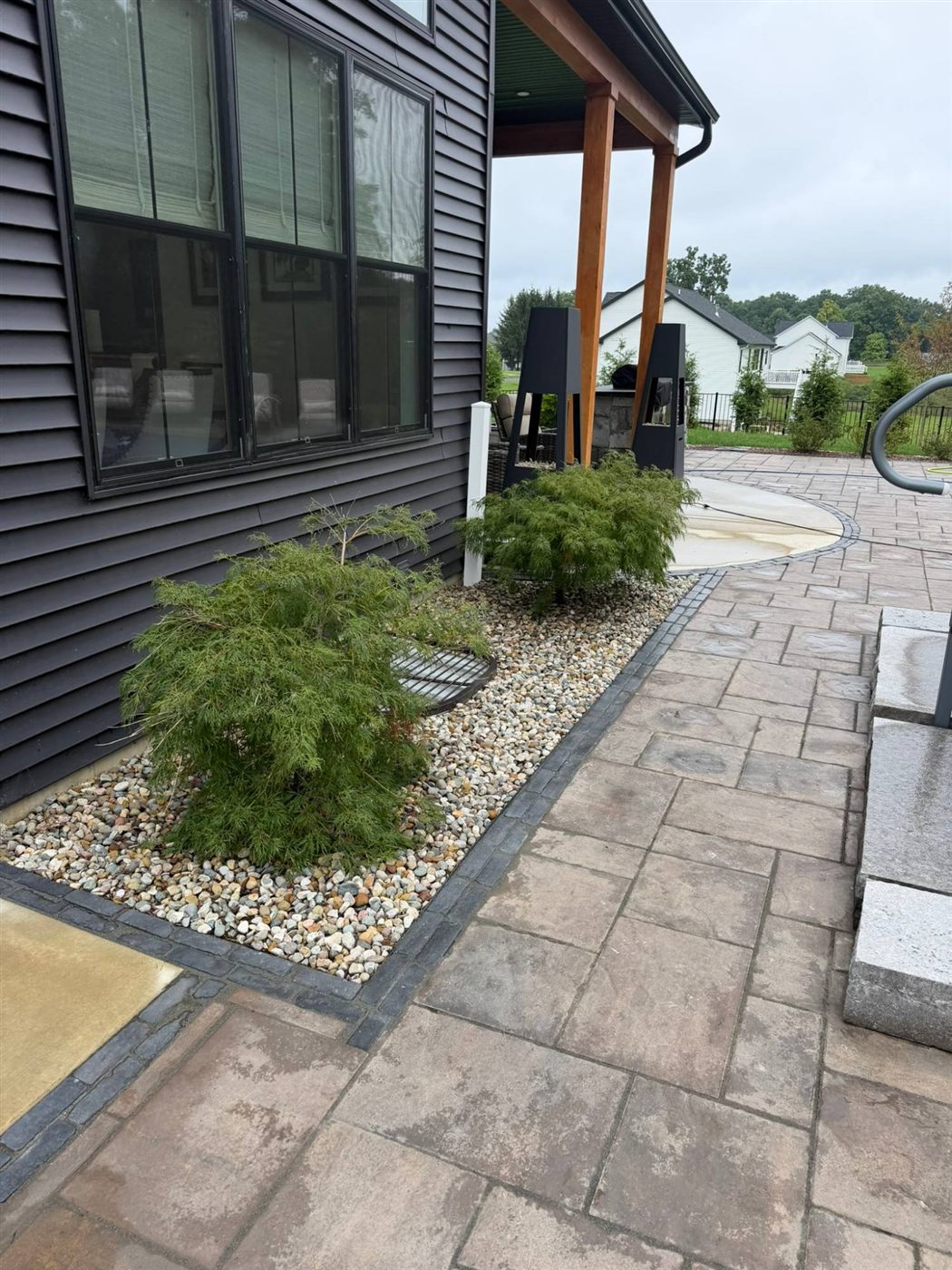 River rock bed with Japanese maples along the paver patio