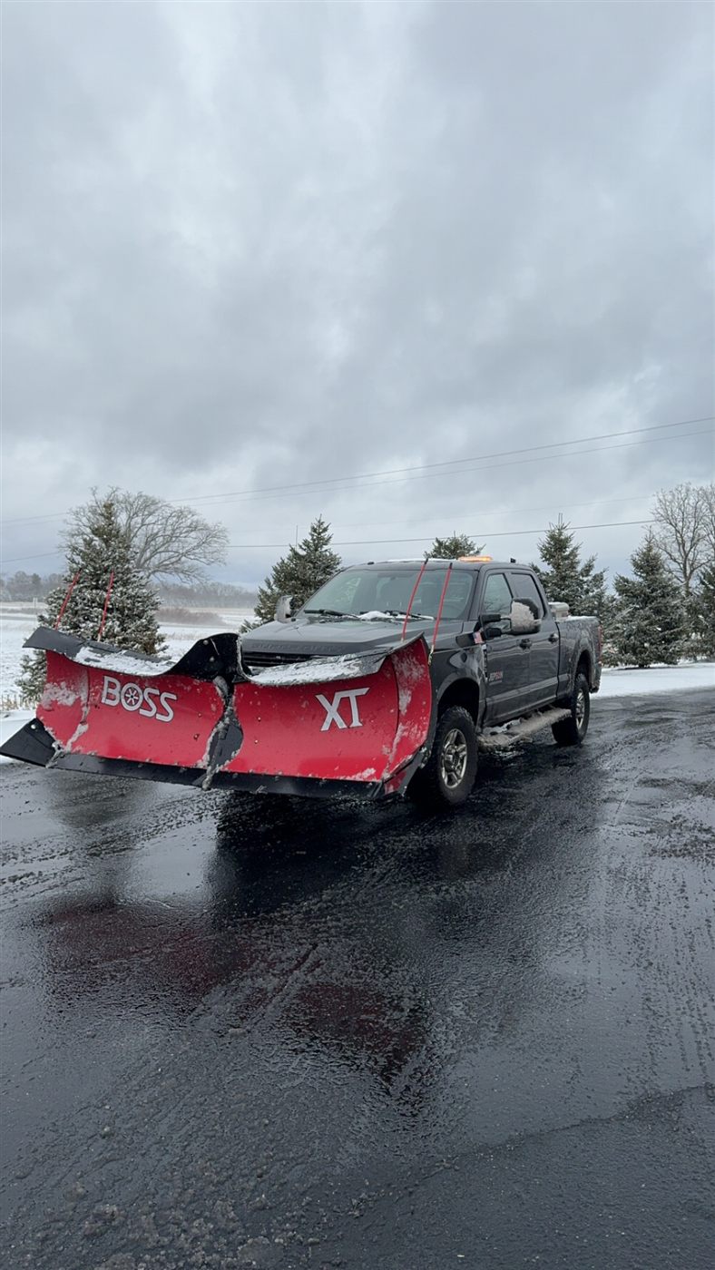 Jepson Landscaping truck plowing a commercial lot