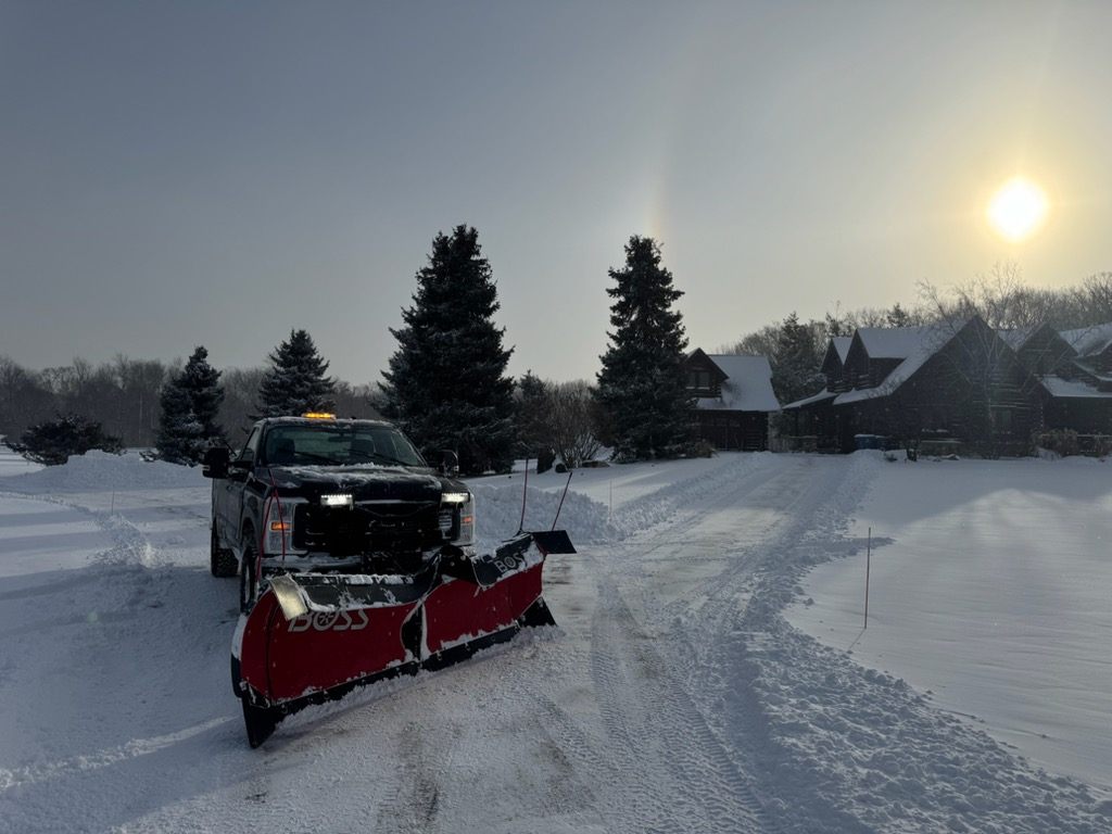 Jepson Landscaping truck plowing a residential driveway