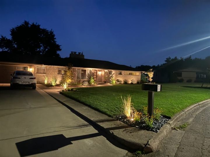 Landscape lighting installation at dusk