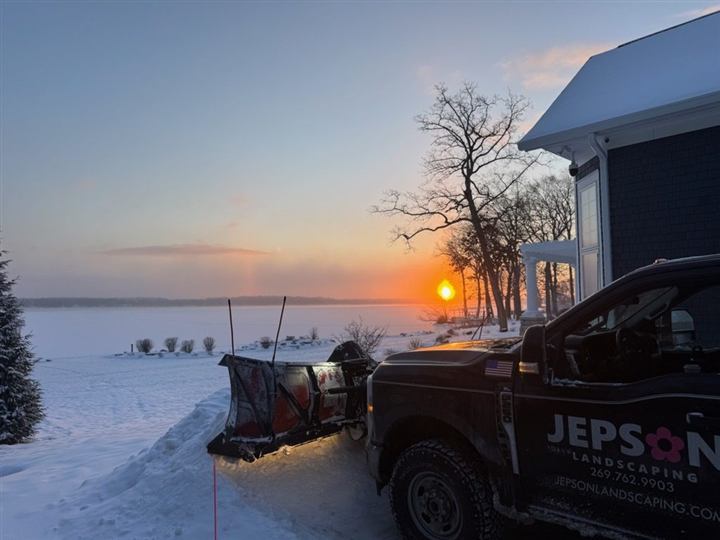 Plow truck at sunset in winter