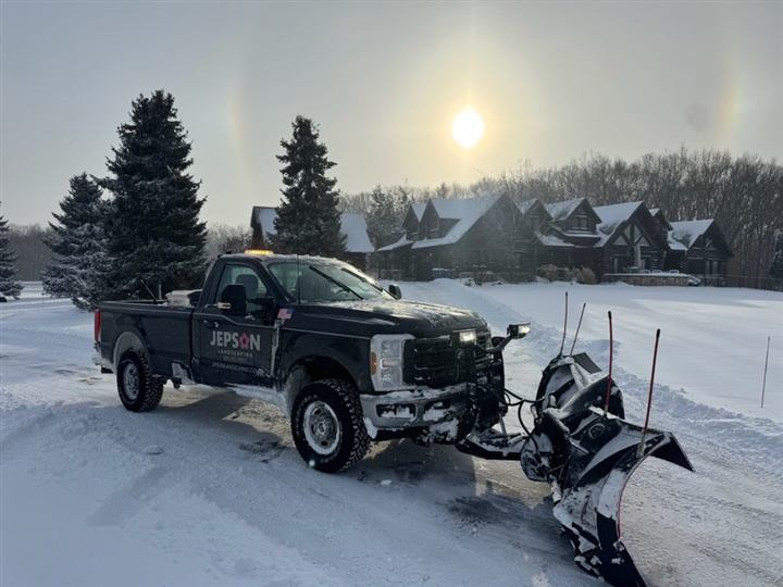 Plow truck at sunset in winter