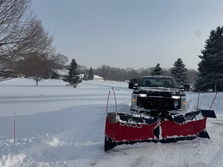 Plow clearing a driveway